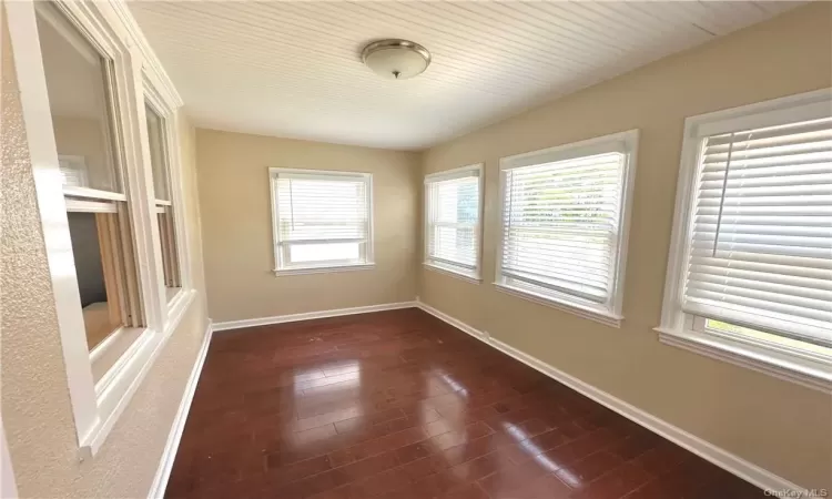 Spare room with a healthy amount of sunlight and wood-type flooring