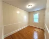 Empty room with hardwood / wood-style flooring