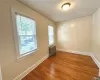 Spare room featuring hardwood / wood-style flooring, plenty of natural light, and radiator