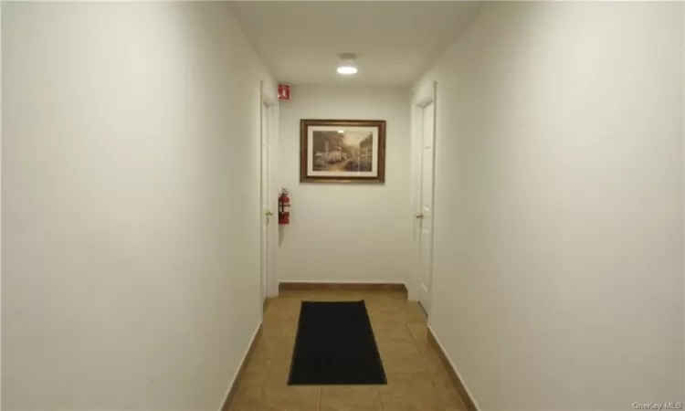 Corridor featuring tile flooring