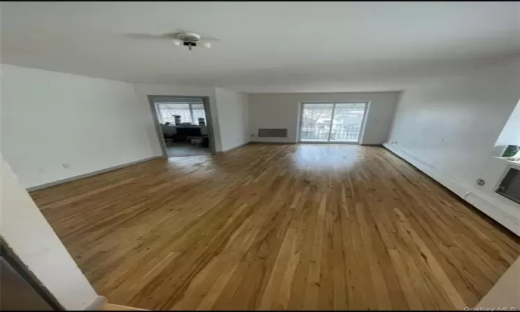 Unfurnished living room with hardwood / wood-style floors