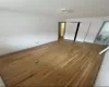 Unfurnished bedroom featuring ensuite bath and hardwood / wood-style flooring