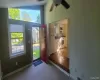 Entryway with a baseboard radiator, lofted ceiling, carpet, and ceiling fan