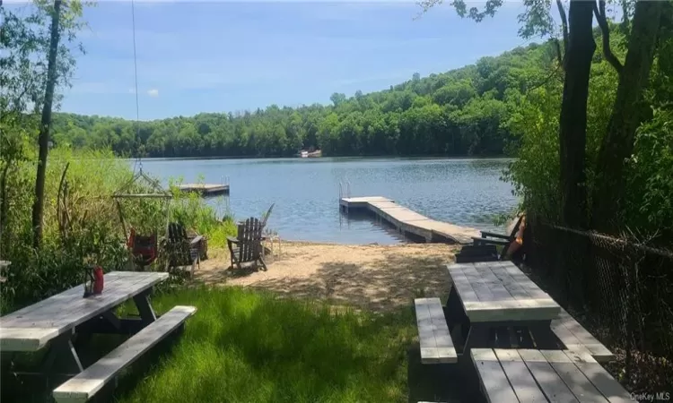 View of dock with a water view picnicing