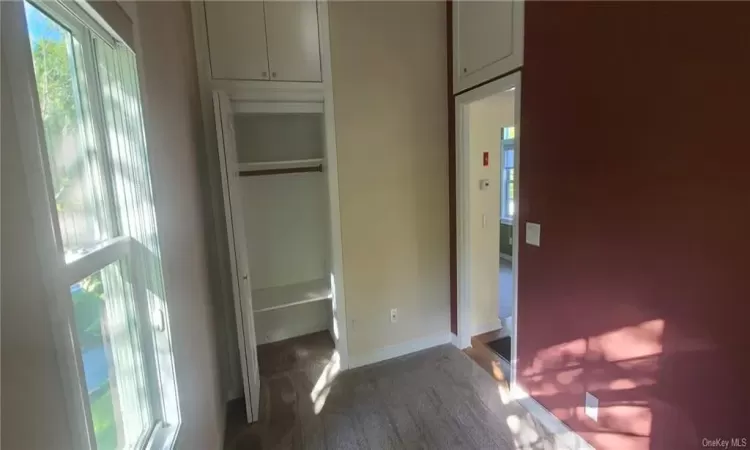 Bedroom with carpet flooring, a closet.