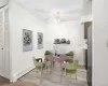 Virtually staged. Dining area featuring a baseboard heating unit, ceiling fan, a textured ceiling, and LVP flooring.