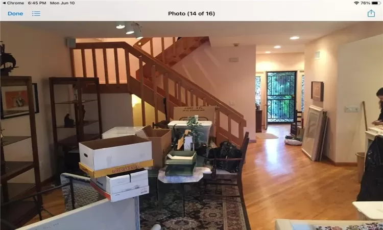 Staircase with light hardwood / wood-style flooring