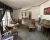 Carpeted living room with ornamental molding, a textured ceiling, and lofted ceiling