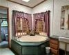 Bathroom featuring crown molding, a textured ceiling, toilet, and a bathing tub