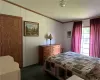 Bedroom with a textured ceiling and dark carpet