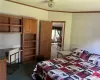 Bedroom featuring ornamental molding, a textured ceiling, and dark carpet