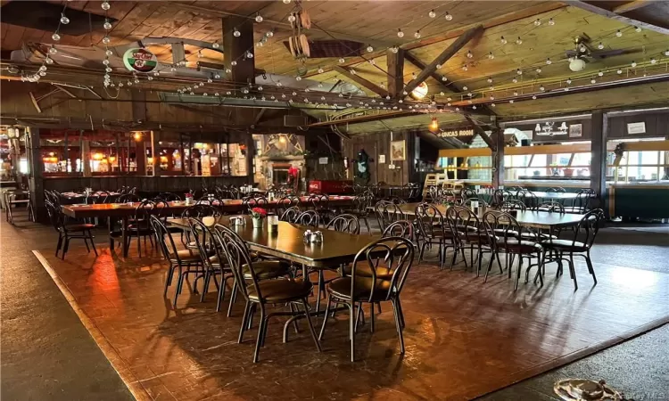 Dining space featuring hardwood / wood-style floors and lofted ceiling