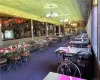 Carpeted dining area featuring a notable chandelier and lofted ceiling