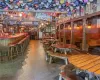 Dining space featuring lofted ceiling and indoor bar