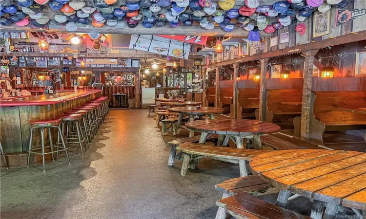 Dining space featuring lofted ceiling and indoor bar