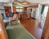 Living room with dark hardwood / wood-style floors, ceiling fan, a healthy amount of sunlight, and vaulted ceiling