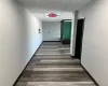 Corridor featuring dark hardwood / wood-style flooring and a drop ceiling