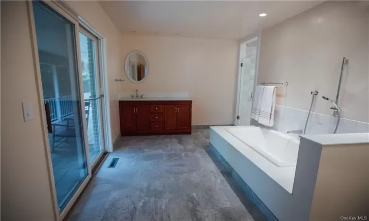 Bedroom featuring hardwood / wood-style flooring and multiple windows