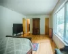 Bedroom with wood-type flooring and two closets