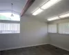 Empty room with vaulted ceiling with beams