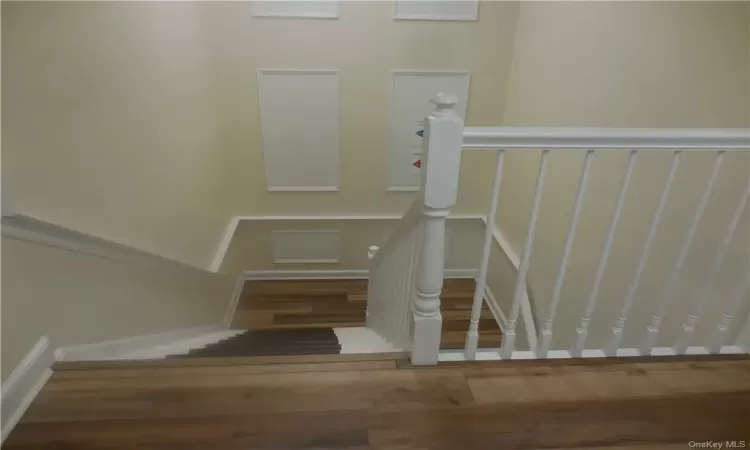 Staircase with hardwood / wood-style flooring