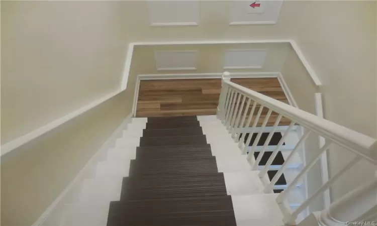 Stairs featuring wood-type flooring