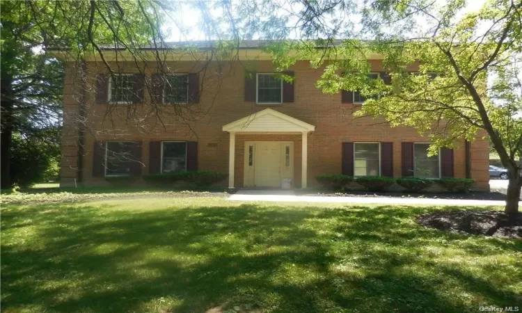 Colonial-style office with a front lawn