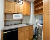 Kitchen featuring sink, black dishwasher, and white microwave