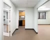 Hall featuring main office space to right, kitchen setup and private office to left