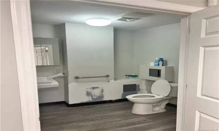 Bathroom featuring sink, hardwood / wood-style flooring, and toilet