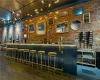 Bar with brick wall and dark wood-type flooring