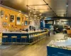 Kitchen with brick wall, a kitchen breakfast bar, wood-type flooring, and rail lighting