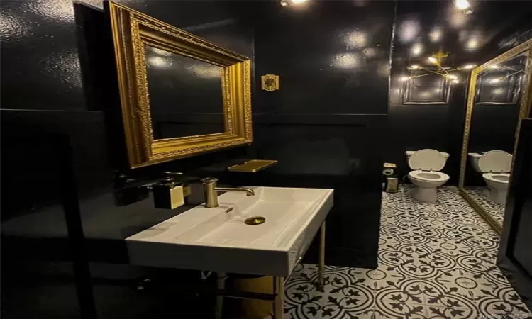 Bathroom with tile flooring, sink, and toilet