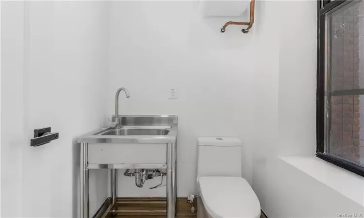 Bathroom featuring sink and toilet