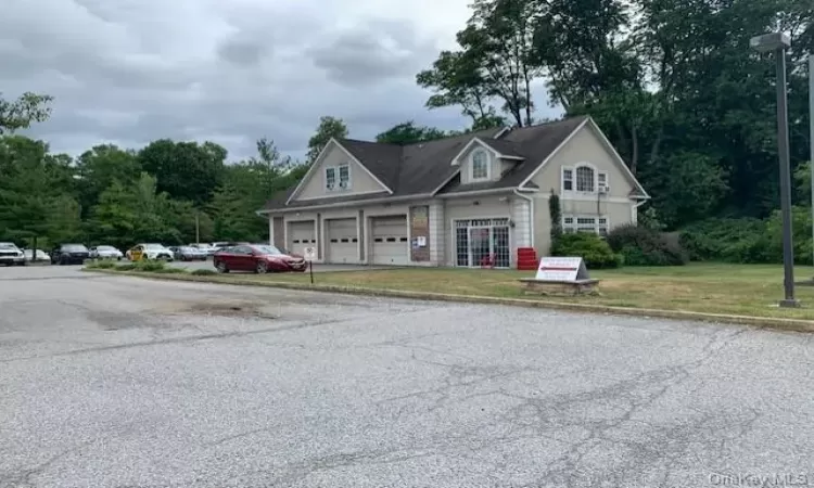 View of front of property with a garage and a front yard