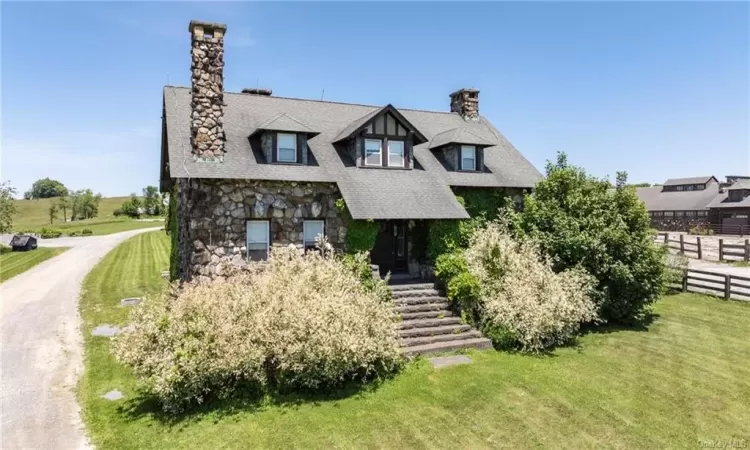 Tudor-style house with a front yard