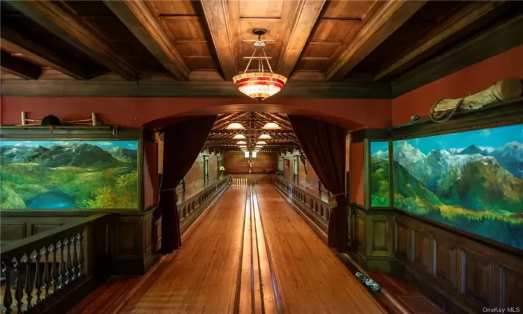 Rec room with beam ceiling, an inviting chandelier, wood ceiling, and wood-type flooring