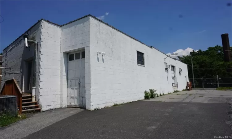 View of side of property with central AC unit