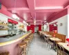 Bar with a wall mounted air conditioner, coffered ceiling, a raised ceiling, and ornamental molding