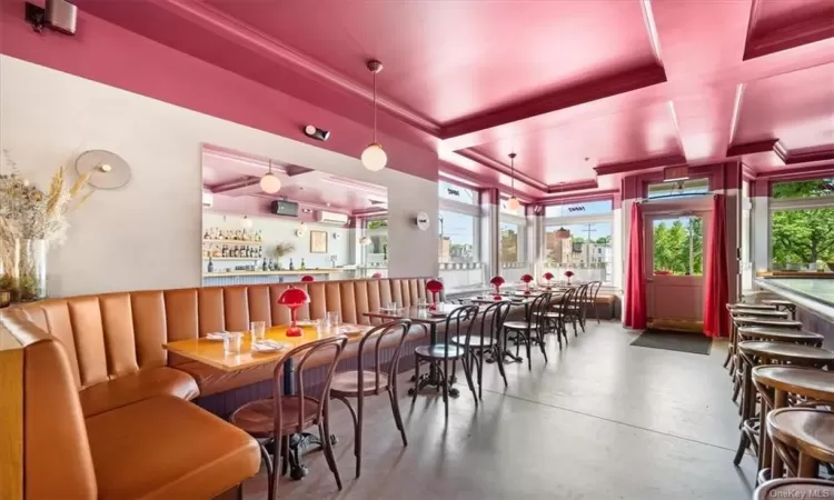 Dining room featuring concrete flooring and a raised ceiling