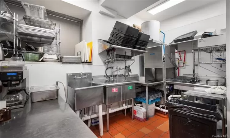 Kitchen featuring stainless steel counters and tile floors