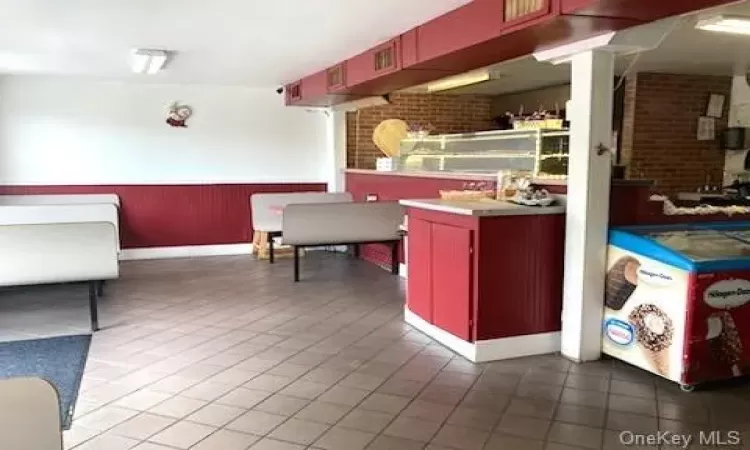 Kitchen with brick wall and tile patterned flooring