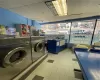 Laundry area with light tile patterned flooring and washing machine and dryer