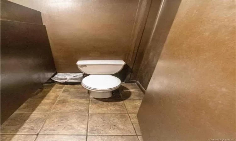 Bathroom with tile patterned flooring and toilet