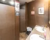 Bathroom featuring a paneled ceiling, tile patterned flooring, and dual bowl vanity