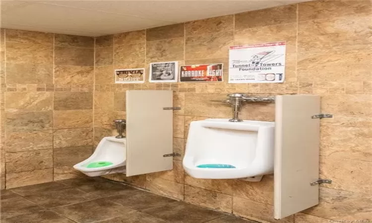 Bathroom with tile patterned flooring and tile walls