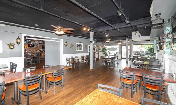 Dining room featuring ceiling fan, track lighting, and hardwood / wood-style floors