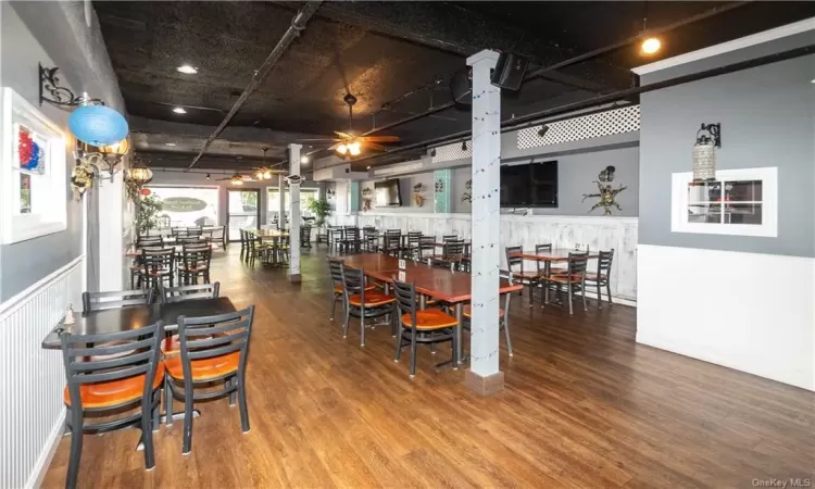 Dining room with hardwood / wood-style floors and ceiling fan