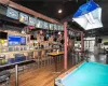 Playroom with indoor bar, hardwood / wood-style floors, billiards, and ceiling fan