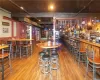 Bar with pool table, hardwood / wood-style flooring, and hanging light fixtures